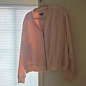 A mid length light jacket with two pockets.